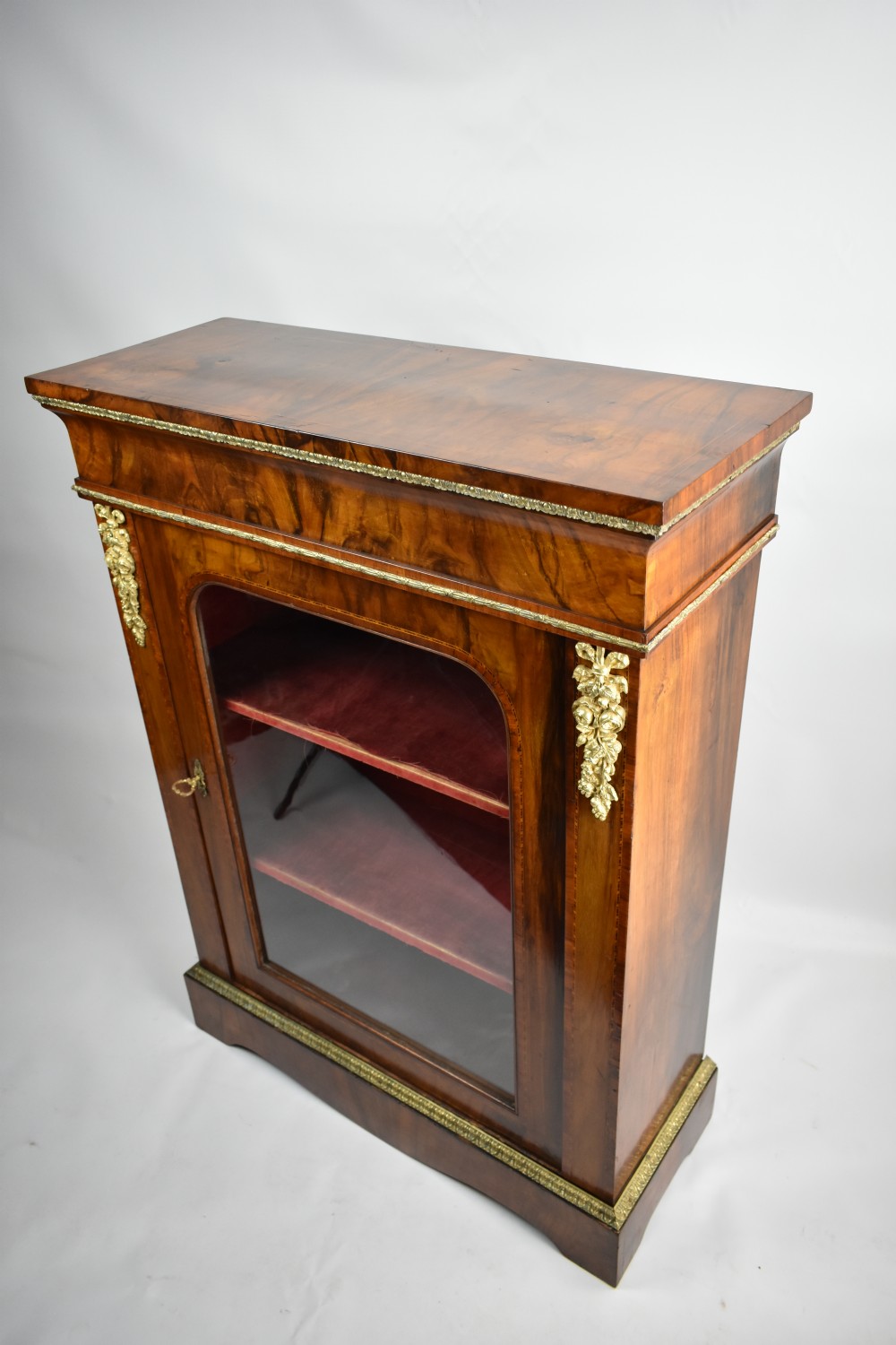 a mid victorian figured walnut and tulipwood banded pier cabinet with ormolu mounts