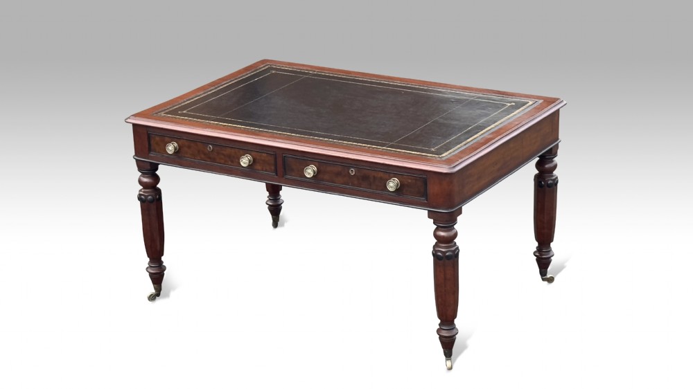 a double sided regency mahogany ebonised partners library table